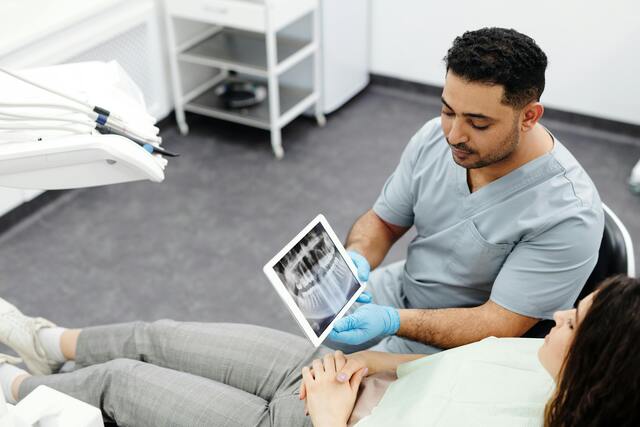 male dentist with x ray teeth