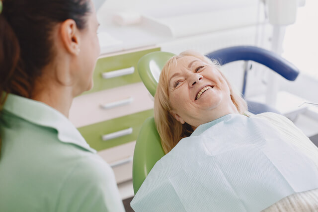 senior woman having dental treatment dental chair dentist